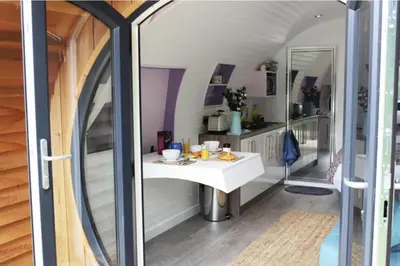 a room with a white table and a mirror at The Heron's Tree in Llandovery