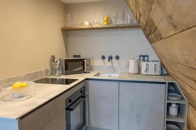 a small kitchen with a sink and a microwave at The Tri-Pod in Llanarth