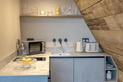 a kitchen with a bowl of fruit on a counter at The Tri-Pod in Llanarth