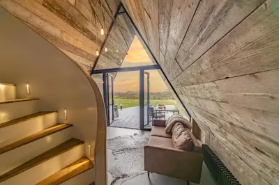 a room with a large window and a couch at The Tri-Pod in Llanarth