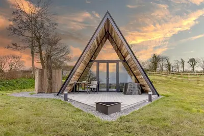 a triangular house in the middle of a field at The Tri-Pod in Llanarth