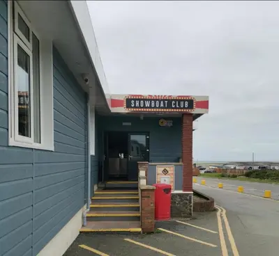 a building with a sign that reads subway club at No. 4 Sunny Lodge By The Sea in Aberystwyth