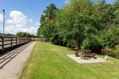 a park with a picnic table and a tree at Stunning studio flat with dedicated private garden in Shrewsbury