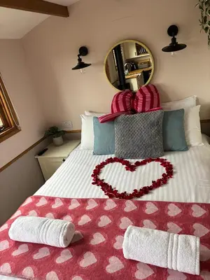 a bedroom with a bed with a heart on it at Hafod Shepherd Hut in Aberystwyth