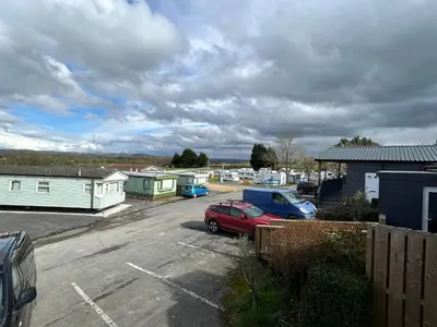 a parking lot with two cars parked in it at Hafod Shepherd Hut in Aberystwyth