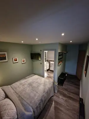 a bedroom with a large bed in a room at Harlech House in Harlech