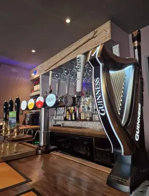 a bar with a large instrument on the counter at Harlech House in Harlech