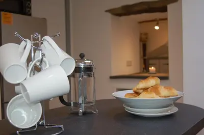 a bowl of bread sitting on a counter with a juicer at Ty Del - Beautiful Home in Tywyn in Tywyn