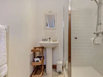 a white bathroom with a sink and a shower at 2 Bed in Llanwrtyd Wells 94009 in Beulah