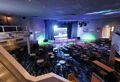a large room with tables and chairs in a restaurant at HARRIES LODGE QUAY WEST milkwood way in New Quay