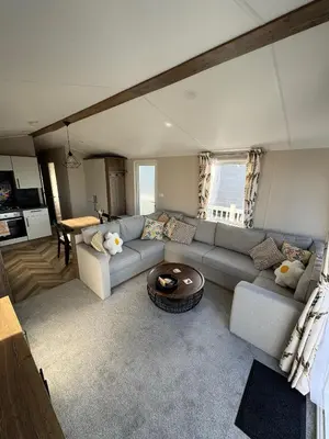 a living room with a couch and a table at Sea La Vie Lodge in New Quay