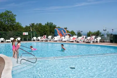 a group of children playing in a swimming pool at Sea La Vie Lodge in New Quay