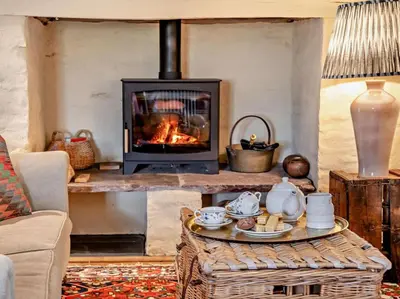 a living room with a fireplace and a coffee table at 3 Bed in Brecon oc-94434 in Velindre