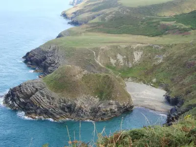 an aerial view of a rocky island in the ocean at Caerhafod Llangrannog in Llanllwchaiarn