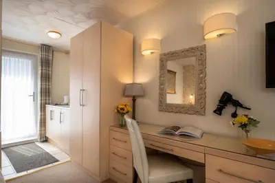 a home office with a desk and a mirror at Estuary Lodge Motel in Talsarnau