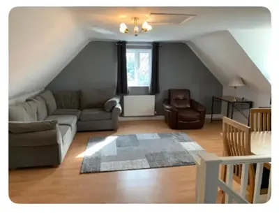 a living room with a couch and a chair at The Little House, Oswestry in Oswestry