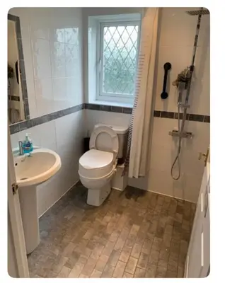 a bathroom with a toilet and a sink and a shower at The Little House, Oswestry in Oswestry