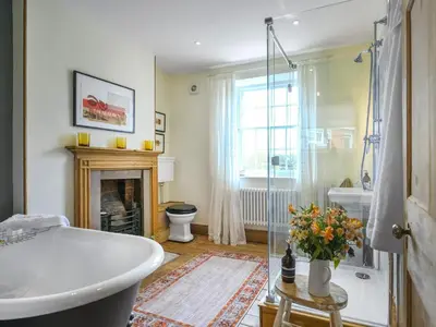 a bathroom with a bath tub and a fireplace at The Haven in Ludlow