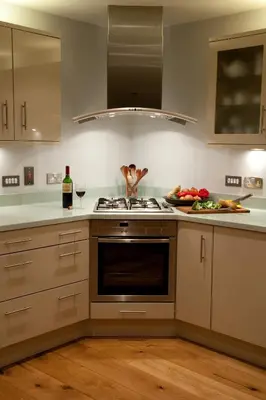 a kitchen with a stove and a person standing on the counter at Hay Retreats in Hay-on-Wye