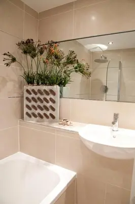 a bathroom with a white sink and a mirror at Hay Retreats in Hay-on-Wye