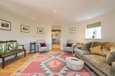 a living room with a couch and a rug at The Hop Kiln in Leominster