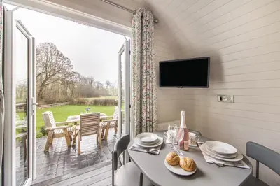 a dining room with a table and a large window at 1 Bed in Llanfyllin oc-p29023 in Llanfyllin