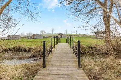 a wooden walkway leading to a field with a bridge at 1 Bed in Llanfyllin oc-p29023 in Llanfyllin