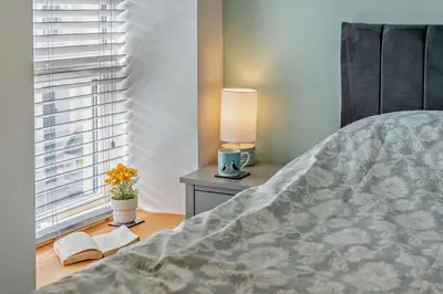 a bedroom with a bed and a lamp and a window at 2 Bed in Aberaeron oc-t29116 in Aberaeron