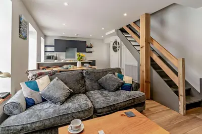 a living room with a couch and a staircase at 2 Bed in Aberaeron oc-t29116 in Aberaeron
