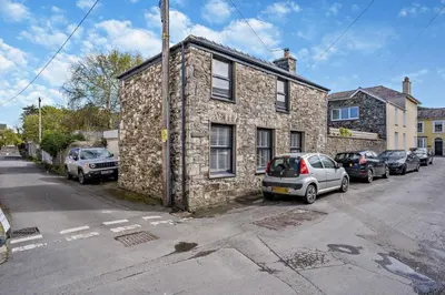 a stone building with cars parked in front of it at 2 Bed in Aberaeron oc-t29116 in Aberaeron