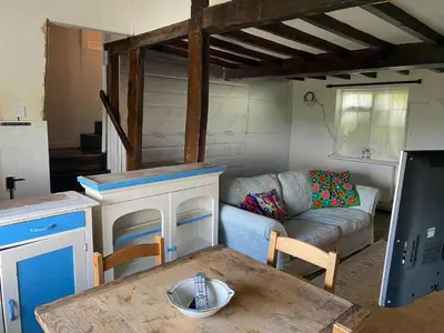 a living room with a couch and a table at Bryntirion Farmhouse Rooms (with bathroom) in Llanfair Caereinion