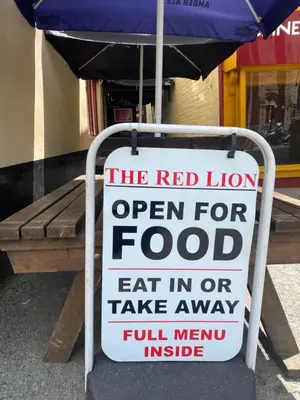 a sign for a red lion open for food at Bryntirion Farmhouse Rooms (with bathroom) in Llanfair Caereinion