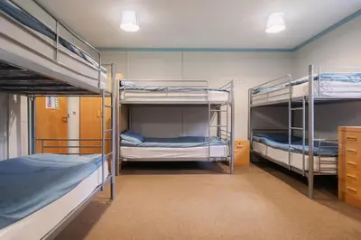 a room with three bunk beds in it at Rural Group Lodging 19 rooms 83 beds Games room in Elerch