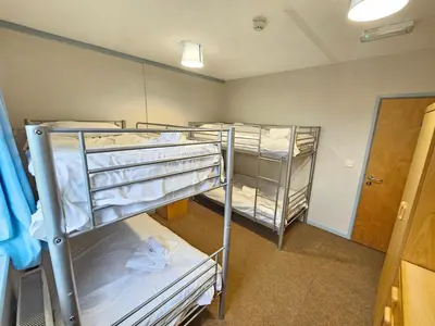 a room with three bunk beds in it at Rural Group Lodging 19 rooms 83 beds Games room in Elerch