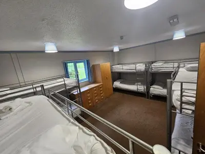 a room with three bunk beds and a window at Rural Group Lodging 19 rooms 83 beds Games room in Elerch