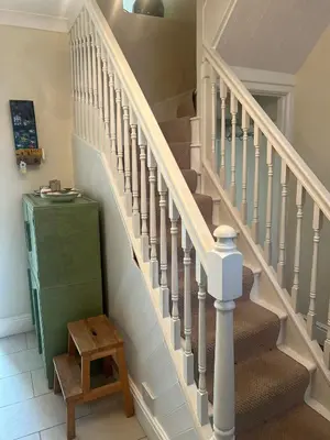 a staircase in a house with a green cabinet at Nant Meigan, Georgian Townhouse in centre of Aberaeron, dog friendly in Aberaeron