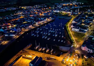 an aerial view of a harbor at night with boats at Nant Meigan, Georgian Townhouse in centre of Aberaeron, dog friendly in Aberaeron