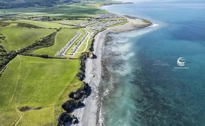 an aerial view of a beach and the ocean at Bayview at Pengarreg in Llanrhystyd