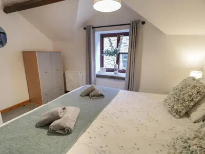 a bedroom with a large bed with towels on it at Graig Las The Stables in Oswestry