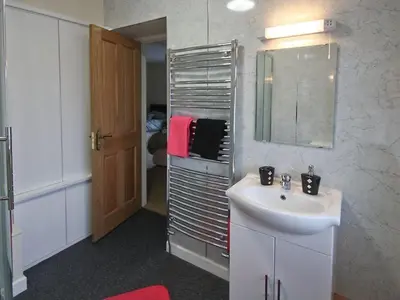 a bathroom with a sink and a mirror at Cob Cottage in Tregaron