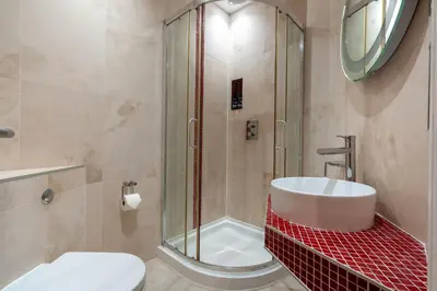 a bathroom with a shower and a toilet and a sink at Gwesty Cymru in Aberystwyth