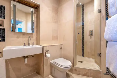 a bathroom with a toilet and a sink and a shower at Gwesty Cymru in Aberystwyth