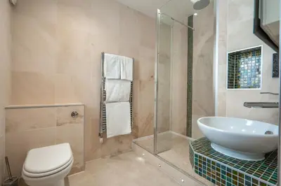 a bathroom with a sink and a toilet and a shower at Gwesty Cymru in Aberystwyth