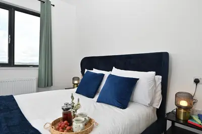 a bed with blue pillows and a basket of fruit on it at Cae Dafadd in Newtown