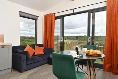 a living room with a couch and a table at Cae Bedw in Newtown