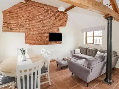 a living room with a brick wall at Uk46555 - Ragleth in Church Stretton