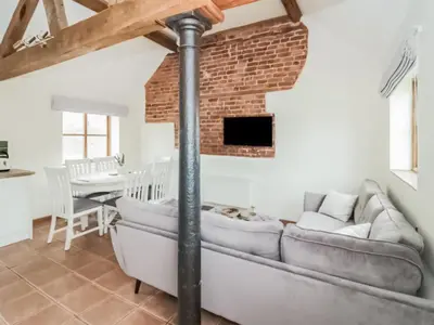 a living room with a couch and a brick wall at Uk46555 - Ragleth in Church Stretton