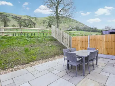 a patio with a table and chairs and a fence at Uk46555 - Ragleth in Church Stretton