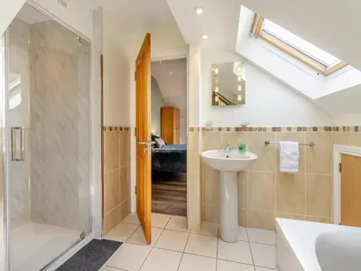 a bathroom with a sink and a shower and a toilet at Derwen Haidd in Llanafan