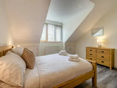 a bedroom with a bed with two towels on it at Derwen Haidd in Llanafan